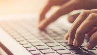 person typing on a laptop